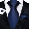 blue tie and a suit with other business acccesoires